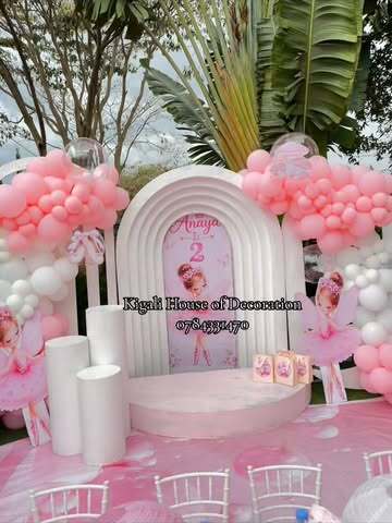 Ballerina birthday setup with white arch and pink balloons