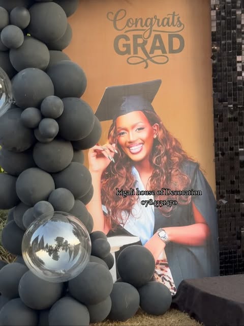 Graduation celebration with dark balloon garland and portrait