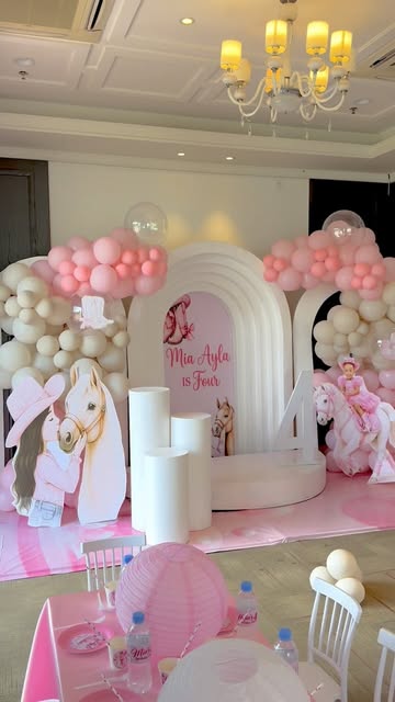 Fourth birthday: layered white arch, pink and cream balloons, pony cutouts